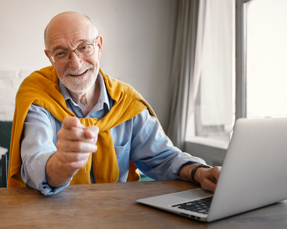 happy older man surfing the Internet