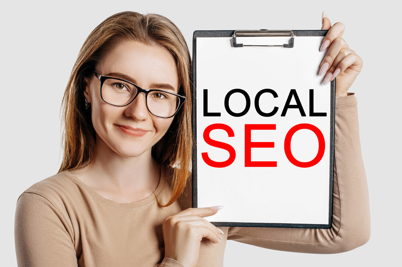 woman holding sign saying "local SEO"