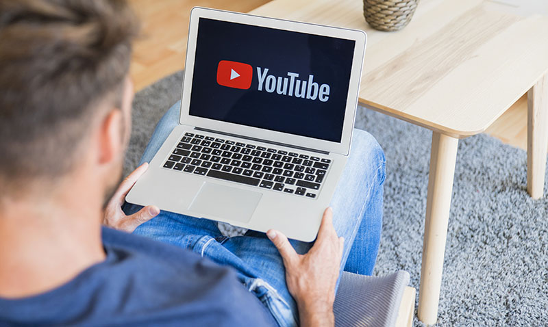 marketer looking at YouTube on laptop