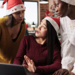 three women writing holiday marketing email content