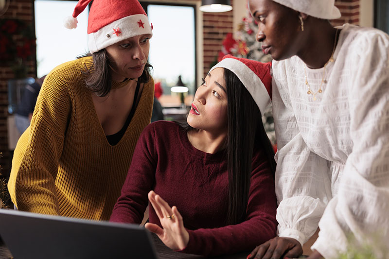 three women writing holiday marketing email content