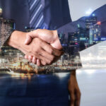 Marketing agency owner shaking hands with ideal client