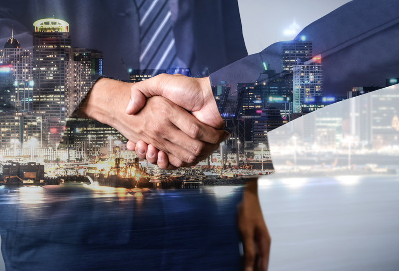 Marketing agency owner shaking hands with ideal client